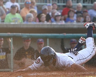 Mahoning Valley Scrappers short stop Jesse Berardi (52) slides into home after being tagged out by West Virginia Black Bears catcher Yoel Gonzalez (48) in the third inning against the Mahoning Valley Scrappers/West Virginia Black Bears, Tuesday, July 4, 2017, at Eastwood Field in Niles...(Nikos Frazier | The Vindicator)..