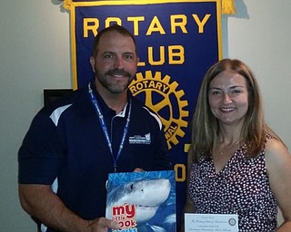 Rotary Club of Austintown recently held a meeting with guest speaker Millie Baldwin, president of Delta Telecom in Poland. Baldwin emphasized the changes and challenges of the communications industry, promising personalized service from herself and her staff that a local company can provide as well as tech support and cost savings. Baldwin also spoke of some of recent innovations in the commercial field that will have an impact on home service. From left are Ed Kalaher, Rotary president presenting a book to Baldwin that will be placed in the Austintown Elementary School Library.