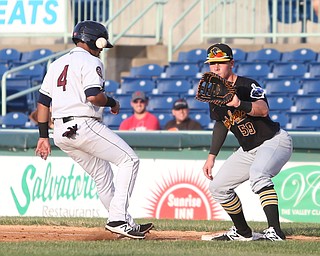 Mahoning Valley Scrappers catcher Gianpaul Gonzalez (4) steps back onto first base as West Virginia Black Bears outfielder Lucas Tancas (59) leans down for the ball in the third inning against the Mahoning Valley Scrappers/West Virginia Black Bears, Wednesday, July 5, 2017, at Eastwood Field in Niles. ..(Nikos Frazier | The Vindicator)..
