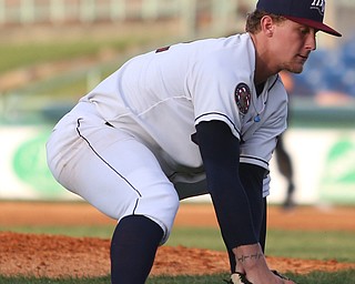 Mahoning Valley Scrappers pitcher Zach Plesac (22) reaches down for the ball before throwing to first to out West Virginia Black Bears third baseman Dylan Busby (18) in the fourth inning against the Mahoning Valley Scrappers/West Virginia Black Bears, Wednesday, July 5, 2017, at Eastwood Field in Niles. ..(Nikos Frazier | The Vindicator)..