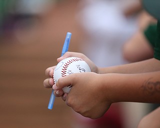 A young fan leans over the railing to the dugout as he waits for autographs from the Scrappers players before the Mahoning Valley Scrappers take on the West Virginia Black Bears, Thursday, July 6, 2017, at Eastwood Field in Niles. ..(Nikos Frazier | The Vindicator)..