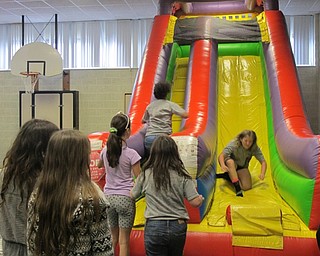 Neighbors | Alexis Bartolomucci.Students played on the inflatable slide during their fun day on May 26 at Robinwood Lane Elementary.