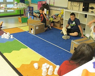 Neighbors | Alexis Bartolomucci.Students at the Austintown Camp Invention program hit boxes they created to try and see how many styrofoam cups they could knock over with the wind they created.