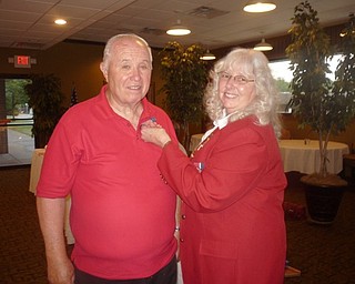 Neighbors | Submitted.Lion PDG Bob Whited is pictured receiving the Silver Centennial Pin from District Governor Betty Robbins at the Installation of Officers on June 19.