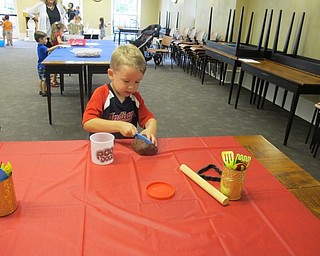 Neighbors | Alexis Bartolomucci.One of the children played with poo-dough during the Captain Underpants program at the Poland library on June 23.