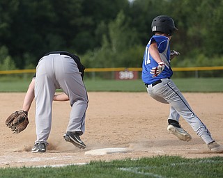 Boardman first baseman David Cross (72) misses a ground ball in the second inning to allow Poland pitcher Mason Planey (11) to run to second as Boardman takes on Poland, Friday, July 7, 2017, at Fields of Dreams in Boardman. Poland won 12-7...(Nikos Frazier | The Vindicator)..