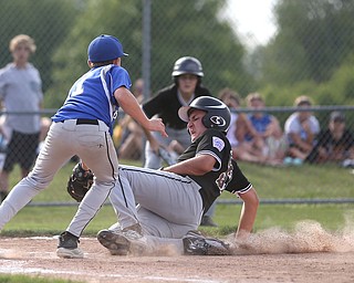 Poland pitcher Mason Planey (11) runs to tag out Boardman third baseman Anthony Micco (33) as he slides into home in the second inning as Boardman takes on Poland, Friday, July 7, 2017, at Fields of Dreams in Boardman. Poland won 12-7...(Nikos Frazier | The Vindicator)..
