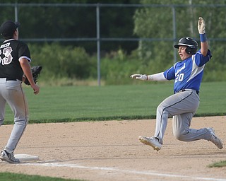 Poland third baseman Christian Colosimo (20) slides into third as Boardman third baseman Anthony Micco (33) waits for the ball in the third inning as Boardman takes on Poland, Friday, July 7, 2017, at Fields of Dreams in Boardman. Poland won 12-7...(Nikos Frazier | The Vindicator)..