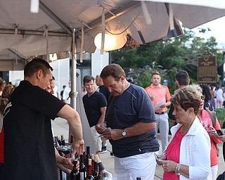 Judy Takach(right) and Tony Fire(center) of Struthers purchase wine from Luva Bella Winery during the Youngstown Jazz and Wine Fest, Saturday, July 8, 2017 in Central Square in downtown Youngstown...(Nikos Frazier | The Vindicator)