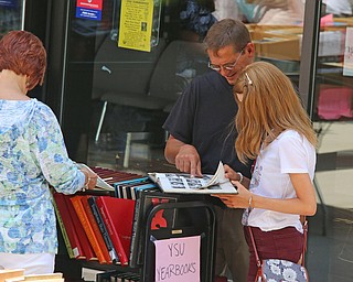 John Donadee of North Lima looks through old YSU Yearbooks with his daughter Olivia during the Summer Festival of the Arts at Youngstown State University on Saturday afternoon.  Dustin Livesay  |  The Vindicator  7/8/17  Youngstown State University.