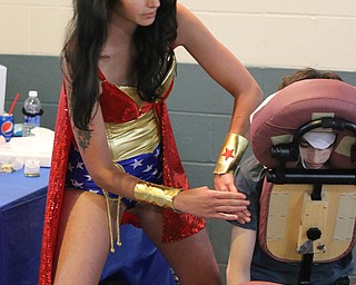 Mason Edwards (13) of McDonald receives a massage from April Yurkovich of Canfield who dressed up as Wonder Woman during the All Americon convention at the Covelli Center in Youngstown on Saturday afternoon.  Dustin Livesay  |  The Vindicator  7/8/17  Covelli Center.