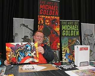 Artist Michael Golden holds up one of his most popular pieces during the All Americon convention at the Covelli Center in Youngstown on Saturday afternoon.  Dustin Livesay  |  The Vindicator  7/8/17  Covelli Center.