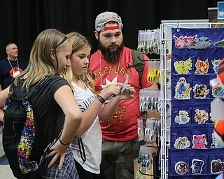 Will Heid of Canfield (right) looks through toys with his sisters Shelbi Heid (middle) of Poland and Rachel Malatok (left) of New Springfield during the All Americon convention at the Covelli Center in Youngstown on Saturday afternoon.  Dustin Livesay  |  The Vindicator  7/8/17  Covelli Center.