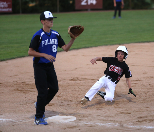 Canfield center fielder Connor Daggett (5) slides into thrid on a steal as Poland third baseman Alec Delsignore (8) waits for the ball in the second inning against Canfield/Poland, Sunday, July 9, 2017, at Fields of Dreams in Boardman. Canfield won 11-0...(Nikos Frazier | The Vindicator)..