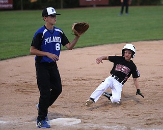 Canfield center fielder Connor Daggett (5) slides into thrid on a steal as Poland third baseman Alec Delsignore (8) waits for the ball in the second inning against Canfield/Poland, Sunday, July 9, 2017, at Fields of Dreams in Boardman. Canfield won 11-0...(Nikos Frazier | The Vindicator)..