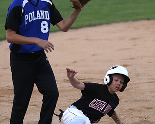 Canfield center fielder Connor Daggett (5) slides into thrid on a steal as Poland third baseman Alec Delsignore (8) waits for the ball in the second inning against Canfield/Poland, Sunday, July 9, 2017, at Fields of Dreams in Boardman. Canfield won 11-0...(Nikos Frazier | The Vindicator)..