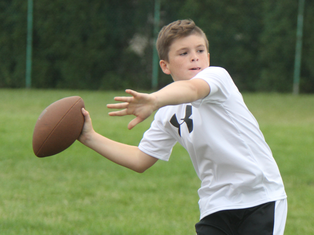 William D Lewis the vindictor   Dylan Casey, 12, of Liberty passes during a football camp at Ursuline HS 7-10-17.