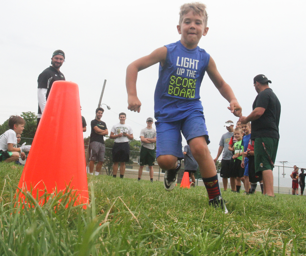 William D Lewis the vindictor   Dominick Balestrino, 7, of Youngstown runs around a cone during a football camp at Ursuline HS 7-10-17.