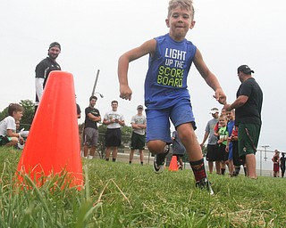 William D Lewis the vindictor   Dominick Balestrino, 7, of Youngstown runs around a cone during a football camp at Ursuline HS 7-10-17.
