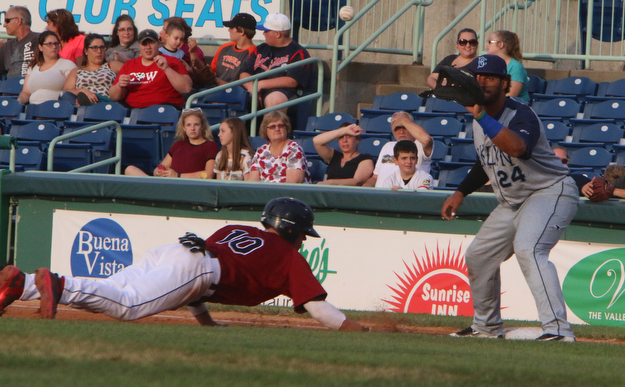 Scrappers baserunner Nolan Jones slides safely under the tag by Brooklyns Jose Maria (24) during Wednesday nights matchup at Eastwood Field.   Dustin Livesay  |  The Vindicator  7/12/17  Eastwood Field.