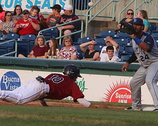 Scrappers baserunner Nolan Jones slides safely under the tag by Brooklyns Jose Maria (24) during Wednesday nights matchup at Eastwood Field.   Dustin Livesay  |  The Vindicator  7/12/17  Eastwood Field.