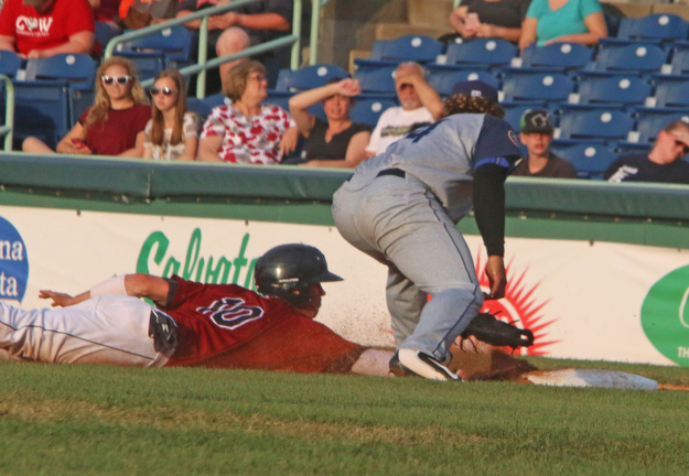 Scrappers baserunner Nolan Jones slides safely under the tag by Brooklyns Jose Maria (24) during Wednesday nights matchup at Eastwood Field.   Dustin Livesay  |  The Vindicator  7/12/17  Eastwood Field.