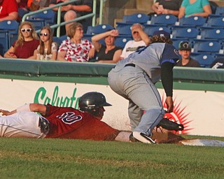 Scrappers baserunner Nolan Jones slides safely under the tag by Brooklyns Jose Maria (24) during Wednesday nights matchup at Eastwood Field.   Dustin Livesay  |  The Vindicator  7/12/17  Eastwood Field.