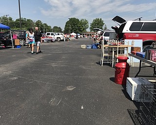 Neighbors | Alexis Bartolomucci.Cars lined up at the Poland Seminary High School parking lot to set out different items for the Treasures of the Trunk sale hosted by the Poland Lions Club.