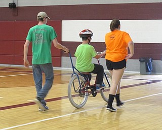 Neighbors | Alexis Bartolomucci.Volunteers helped riders learn how to ride a bicycle during the iCan Bike program hosted by the iCan Shine organization and the Down Syndrome Association of the Valley.