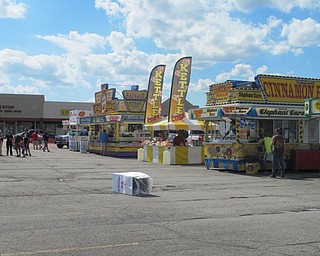 Neighbors | Alexis Bartolomucci.Vendors set up along the Austintown Plaza on July 2 for the fireworks celebration hosted each year.