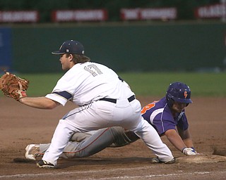 Creekside third baseman Dan Klase (24) leaps back onto first as Golden Spikes first baseman Donny Watters (17) waits for the ball in the third inning as Creekside Fitness takes on the Golden Spikes, Friday, July 14, 2017, at Bob Cene Park in Struthers...(Nikos Frazier | The Vindicator)..