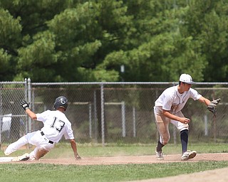 Baird Brothers third baseman Bren Kilpatrick (45) leans down for the ball as Brooklyn Bonnie Paws short stop Antonio Pena (13) slides into third in the fifth inning as the Baird Brothers take on the Brooklyn Bonnie Paws in the 14u NABF World Series Championship, Sunday, July 16, 2017, at Cene Park in Struthers. Brooklyn won 2-0...(Nikos Frazier | The Vindicator)..