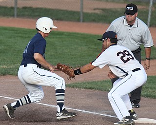 William D. Lewis The Vindicator Astro's first baseman Vinny Mostrangelo(29) picks off Baird's Josh Kieffer(21)1rst game at Cene 7-17-17.