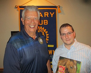 Above, Austintown Rotary president Bruce Laraway, left, presents a book to AdamZagotti, representative of the American Guild of Organists, that will be placed in his honor in the Austintown Elementary School library.  The guild held a convention in Youngstown recently for the first time since 1926.