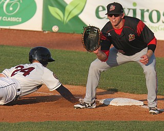 William D. Lewis the vindicator Srappers Ernie Clement(24) dives back to first as  Batavia's FBman Ben Fisher(36) waits for the throw during 7-18-17 game