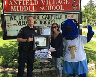 Neighbors | Submitted.Farmers National Bank presented Canfield Police Chief Chuck Colucci with a check for $500 as part of Canfield Village Middle School’s fundraising campaign on May 30. The donation will go toward buying Canfield Police Department’s new police dog, Rocky, a vest.