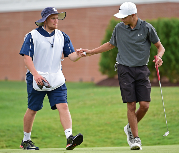 WARREN, OHIO - JULY 22, 2017: Jimmy Graham gets a fist bump from his caddie Ryan Lee after completing his round, Saturday afternoon at the Vindicator's Greatest Golfer of the Valley Jr. Championship at Avalon Lakes. DAVID DERMER | THE VINDICATOR