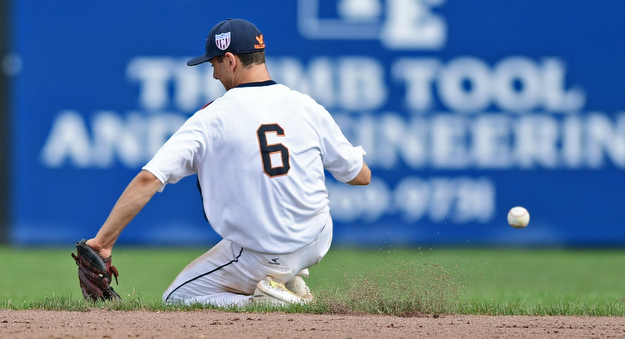 STRUTHERS, OHIO - JULY 23, 2017: Astro's Mike Turconi slides on the dirt after unsuccessfully attempting to backhand a ground ball in the fifth inning of their game Sunday morning against the Ohio Longhorns. Astro won 12-2. DAVID DERMER | THE VINDICATOR