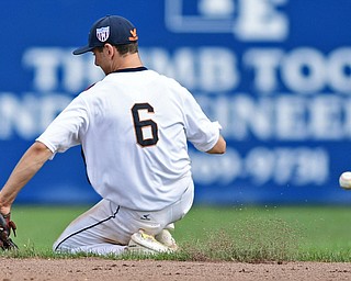 STRUTHERS, OHIO - JULY 23, 2017: Astro's Mike Turconi slides on the dirt after unsuccessfully attempting to backhand a ground ball in the fifth inning of their game Sunday morning against the Ohio Longhorns. Astro won 12-2. DAVID DERMER | THE VINDICATOR