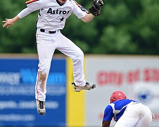 STRUTHERS, OHIO - JULY 23, 2017: Astro's Craig Butler, top, leaps after a high throw from catcher Jack Anderson while 96ers' Albert Hughes steals second base in the third inning of their game Sunday afternoon at Cene Park. The 96ers won 3-2. DAVID DERMER | THE VINDICATOR