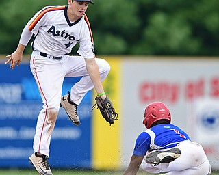 STRUTHERS, OHIO - JULY 23, 2017: Astro's Craig Butler, top, leaps after a high throw from catcher Jack Anderson while 96ers' Albert Hughes steals second base in the third inning of their game Sunday afternoon at Cene Park. The 96ers won 3-2. DAVID DERMER | THE VINDICATOR