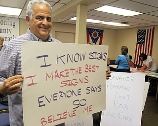 Mahoning County Democratic Party Chairman David Betras displays an anti-Trump sign Monday night.