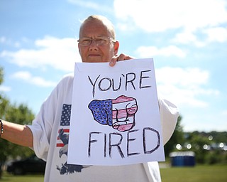 Martha Tomb of Girard holds up a "You're Fired" sign while protesting outside the the Covelli Centre before President Donald J. Trump is scheduled to speak at the Covelli Centre, Tuesday, July 25, 2017 in Youngstown...(Nikos Frazier | The Vindicator)