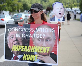 Lynn of Cleveland protests outside the the Covelli Centre before President Donald J. Trump is scheduled to speak at the Covelli Centre, Tuesday, July 25, 2017 in Youngstown...(Nikos Frazier | The Vindicator)