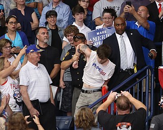 A protestor is removed while President Donald J. Trump speaks at the Covelli Centre, Tuesday, July 25, 2017 in Youngstown...(Nikos Frazier | The Vindicator)