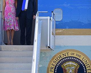 President Donald Trump salutes as he exits Air Force One with first lady Melania Trump at the Youngstown-Warren Regional Airport, Tuesday, Tuesday, July 25, 2017, in Vienna, Ohio. Trump will be speaking at a rally Tuesday at the Covelli Centre in Youngstown, Ohio. (David Dermer/The Vindicator via AP)