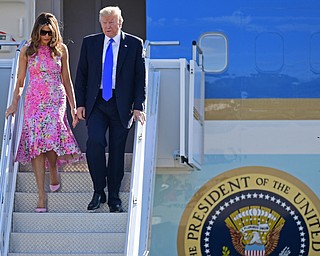 President Donald Trump walks, after exiting Air Force One, with first lady Melania Trump at the Youngstown-Warren Regional Airport, Tuesday, Tuesday, July 25, 2017, in Vienna, Ohio. Trump will be speaking at a rally Tuesday at the Covelli Centre in Youngstown, Ohio. (David Dermer/The Vindicator via AP)
