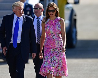 President Donald Trump walks with first lady Melania Trump at the Youngstown-Warren Regional Airport, Tuesday, Tuesday, July 25, 2017, in Vienna, Ohio. Trump will be speaking at a rally Tuesday at the Covelli Centre in Youngstown, Ohio. (David Dermer/The Vindicator via AP)