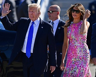 President Donald Trump waves as he walks with first lady Melania Trump at the Youngstown-Warren Regional Airport, Tuesday, Tuesday, July 25, 2017, in Vienna, Ohio. Trump will be speaking at a rally Tuesday at the Covelli Centre in Youngstown, Ohio. (David Dermer/The Vindicator via AP)