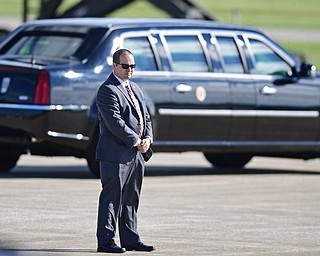 A secret service agent stands on the runway as President Donald Trump motorcade drives away at the Youngstown-Warren Regional Airport, Tuesday, Tuesday, July 25, 2017, in Vienna, Ohio. Trump will be speaking at a rally Tuesday at the Covelli Centre in Youngstown, Ohio. (David Dermer/The Vindicator via AP)